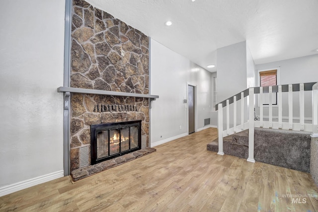 790 Academic Dr, Twin Falls, ID 83301 - living room with a fireplace, visible vents, stairway, wood finished floors, and baseboards