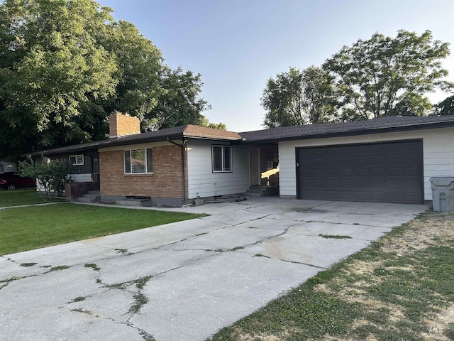 2320 S Illinois, Caldwell, ID 83605 - single story home featuring driveway, an attached garage, a chimney, a front lawn, and brick siding
