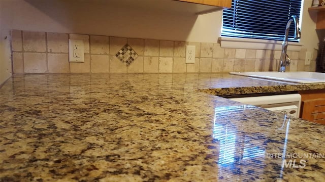 2320 S Illinois, Caldwell, ID 83605 - kitchen featuring backsplash, light stone countertops, and dishwasher