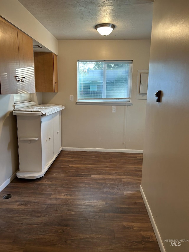 2320 S Illinois, Caldwell, ID 83605 - kitchen with dark wood finished floors, light countertops, a textured ceiling, and brown cabinets