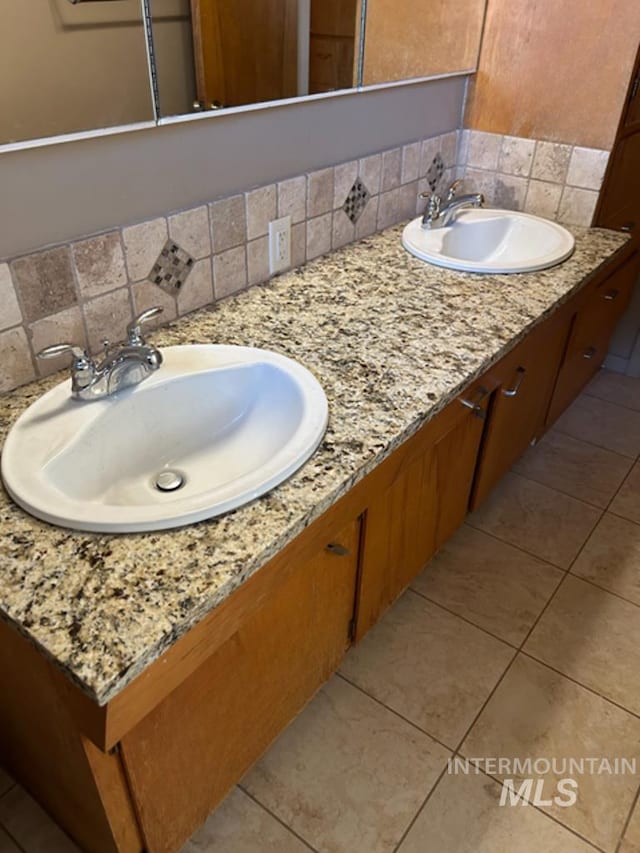 2320 S Illinois, Caldwell, ID 83605 - bathroom with decorative backsplash, double vanity, and tile patterned flooring