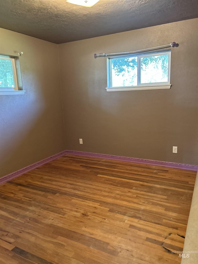 2320 S Illinois, Caldwell, ID 83605 - unfurnished room with wood finished floors and a textured ceiling