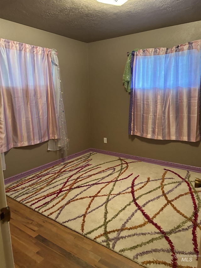 2320 S Illinois, Caldwell, ID 83605 - unfurnished bedroom featuring wood finished floors and a textured ceiling