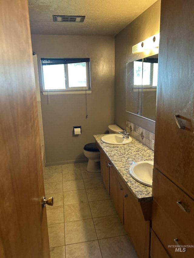 2320 S Illinois, Caldwell, ID 83605 - bathroom with double vanity, tile patterned flooring, and a textured ceiling