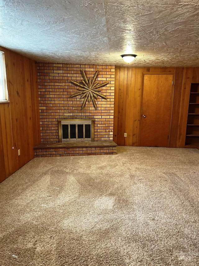 2320 S Illinois, Caldwell, ID 83605 - unfurnished living room featuring a brick fireplace, carpet flooring, wooden walls, and a textured ceiling