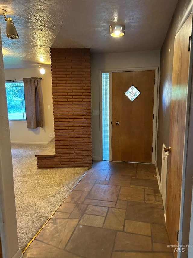 2320 S Illinois, Caldwell, ID 83605 - foyer featuring a textured ceiling and stone tile flooring