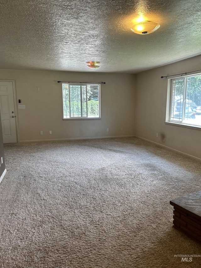 2320 S Illinois, Caldwell, ID 83605 - carpeted empty room featuring plenty of natural light and a textured ceiling
