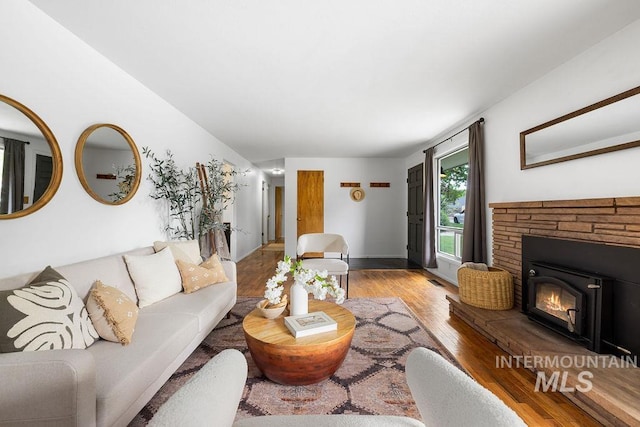5928 W Grunder, Boise, ID 83709 - living room featuring wood finished floors, a fireplace, and baseboards