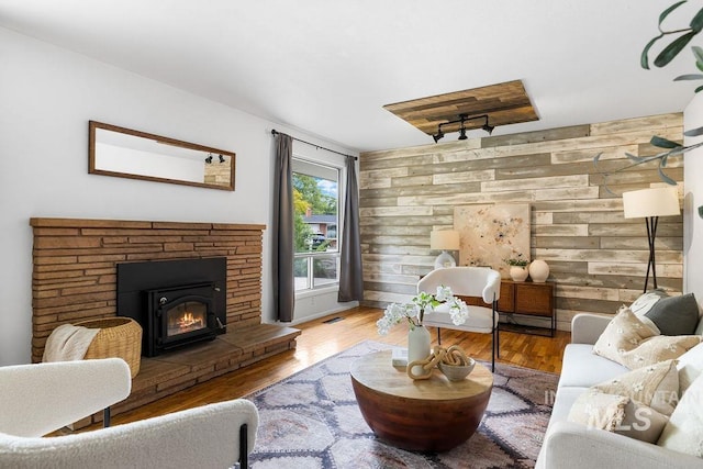 5928 W Grunder, Boise, ID 83709 - living area featuring wood walls, a glass covered fireplace, and wood finished floors