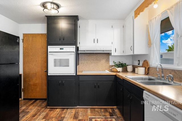 5928 W Grunder, Boise, ID 83709 - kitchen with white appliances, a sink, under cabinet range hood, tasteful backsplash, and dark wood-style floors