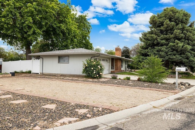 5928 W Grunder, Boise, ID 83709 - ranch-style home with an attached garage, a chimney, and concrete driveway