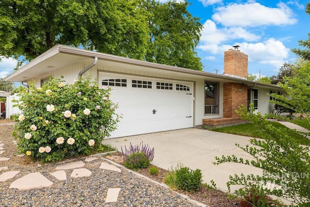 5928 W Grunder, Boise, ID 83709 - ranch-style home featuring a garage, a chimney, and driveway