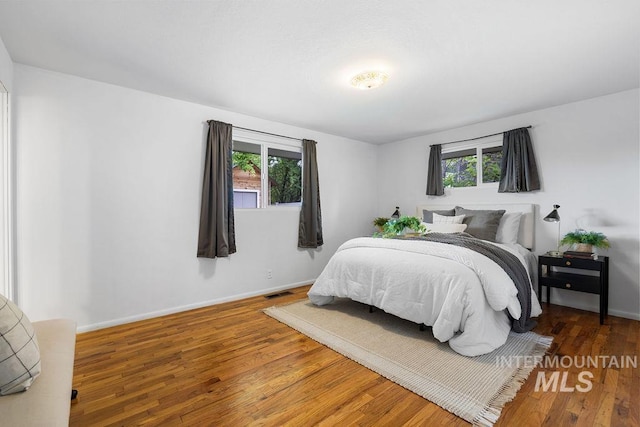 5928 W Grunder, Boise, ID 83709 - bedroom with multiple windows, wood finished floors, and baseboards