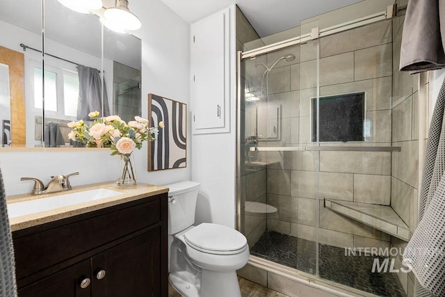 5928 W Grunder, Boise, ID 83709 - bathroom featuring toilet, vanity, a shower stall, and wood finished floors