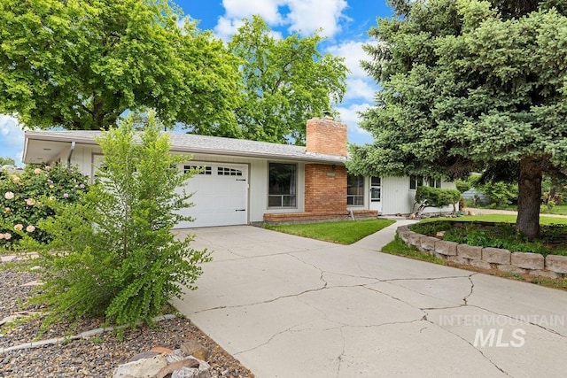5928 W Grunder, Boise, ID 83709 - single story home featuring a garage, a chimney, concrete driveway, and brick siding