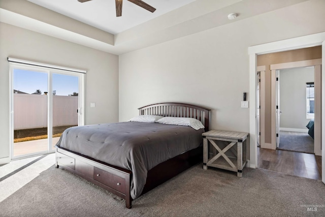 carpeted bedroom featuring access to exterior, a ceiling fan, and baseboards