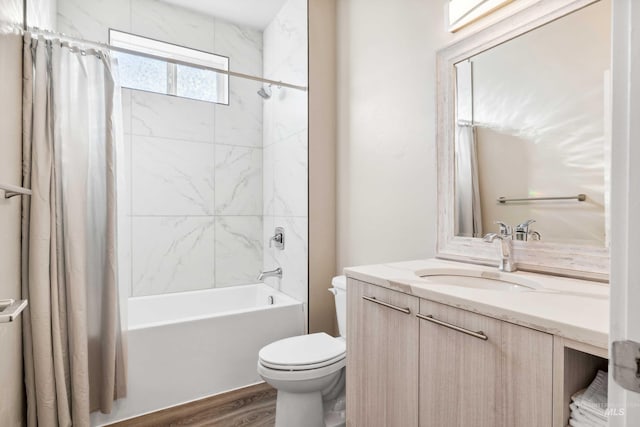 bathroom with vanity, toilet, shower / tub combo, and wood finished floors