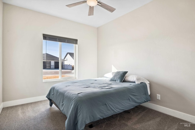 carpeted bedroom featuring baseboards and ceiling fan