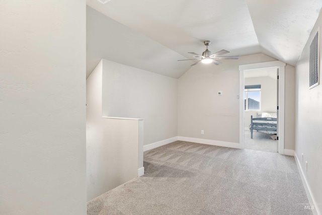 additional living space featuring carpet flooring, ceiling fan, baseboards, and lofted ceiling