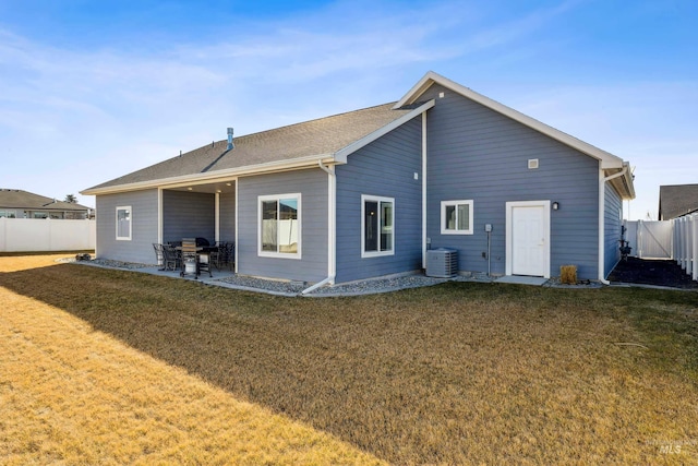 back of house with a patio area, central air condition unit, a lawn, and a fenced backyard