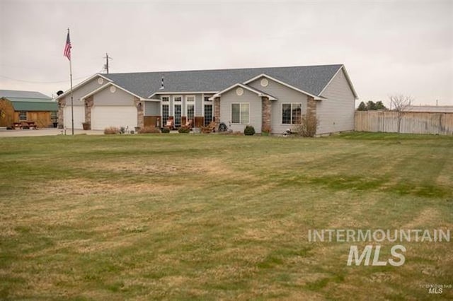 single story home with a front yard and a garage