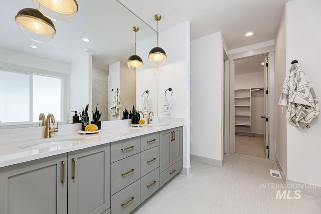 full bath with double vanity, recessed lighting, visible vents, and a sink