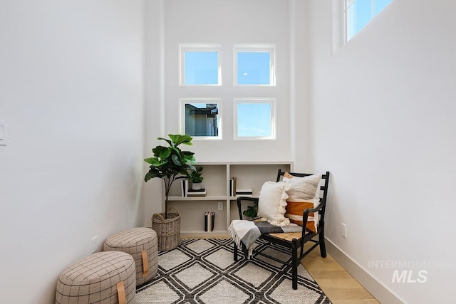 sitting room with light wood-style flooring and baseboards