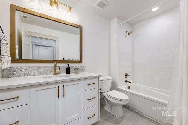 bathroom with visible vents, toilet, shower / bath combo, and vanity