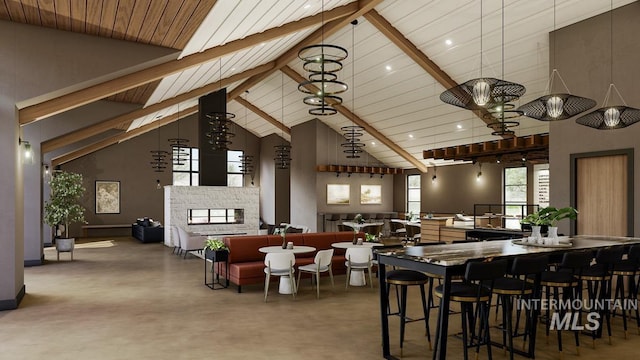 dining room featuring a stone fireplace, beam ceiling, and high vaulted ceiling