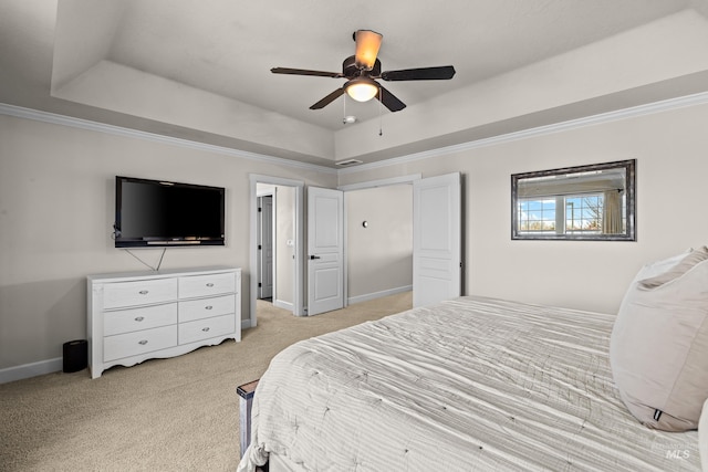 bedroom featuring a tray ceiling, crown molding, light colored carpet, and baseboards