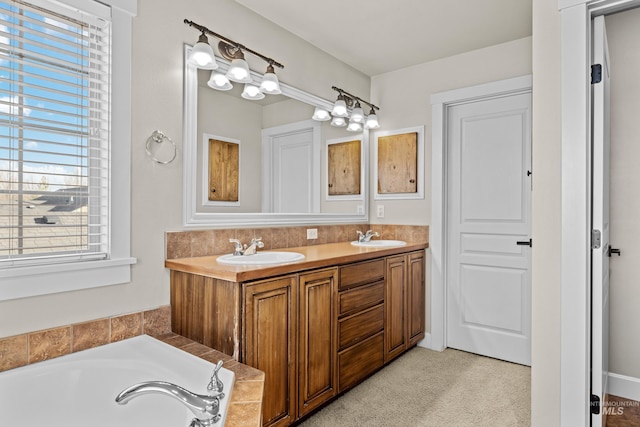 full bathroom featuring double vanity, a garden tub, and a sink