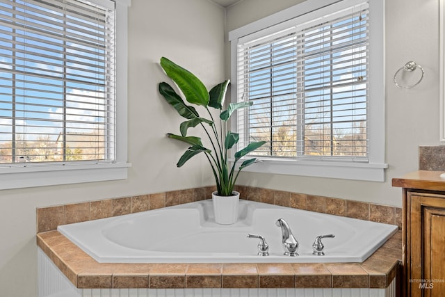 bathroom with vanity and a bath