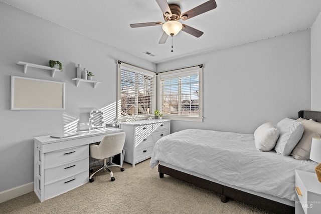 bedroom with ceiling fan, light colored carpet, visible vents, and baseboards