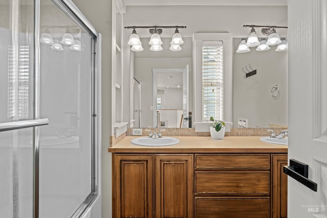 bathroom featuring a sink, a shower stall, and double vanity