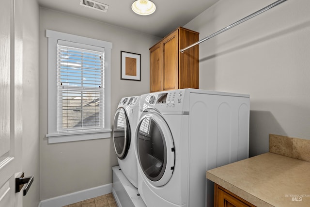 laundry room featuring baseboards, cabinet space, visible vents, and washer and clothes dryer