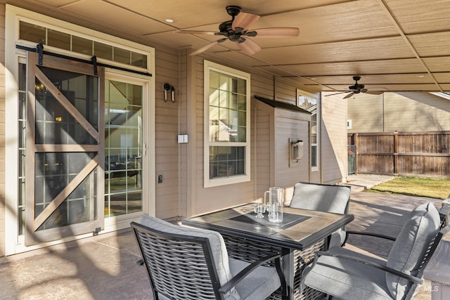 view of patio / terrace featuring outdoor dining space, a ceiling fan, and fence