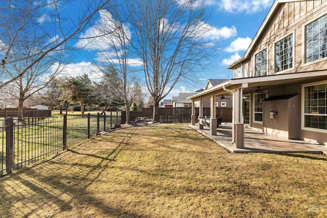 view of yard with a fenced backyard, a ceiling fan, and a patio area