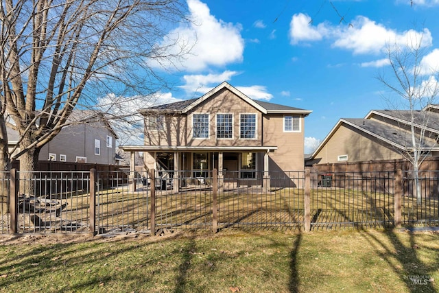 view of front of property with a fenced front yard, covered porch, and a front yard