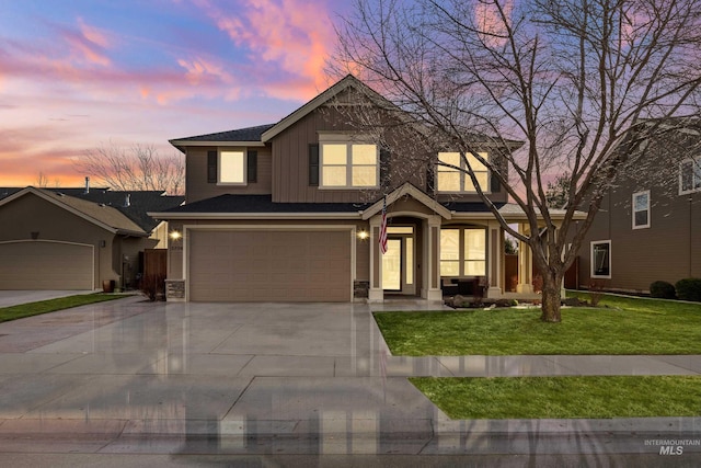 view of front facade with driveway, a yard, a garage, stone siding, and board and batten siding