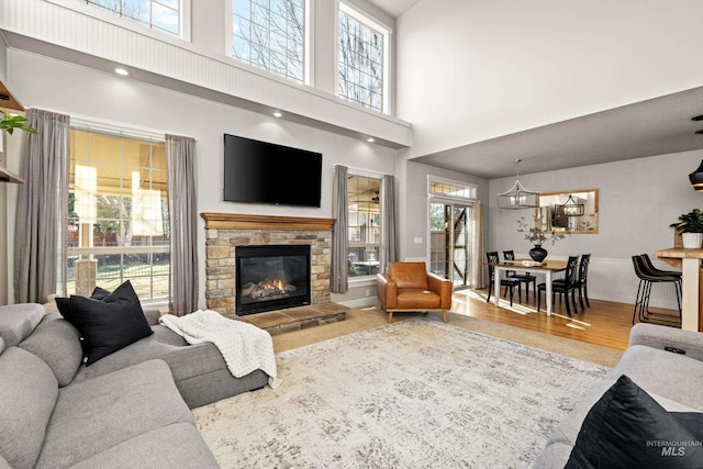 living room featuring a wealth of natural light, a fireplace, and wood finished floors