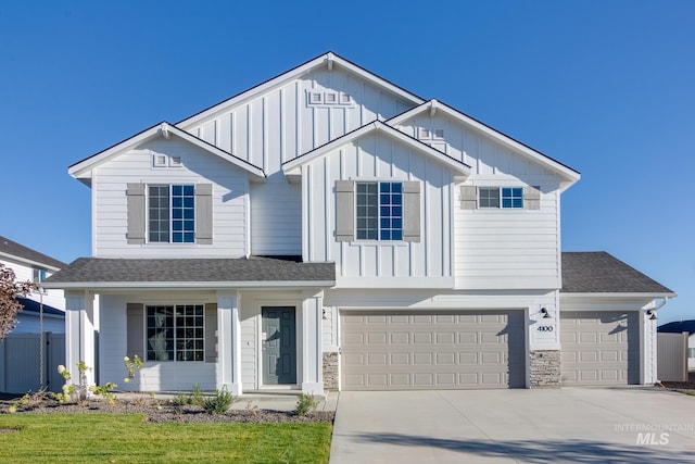 7341 E Dripping Springs Dr, Nampa, ID 83687 - view of front of house featuring board and batten siding, concrete driveway, a garage, and roof with shingles
