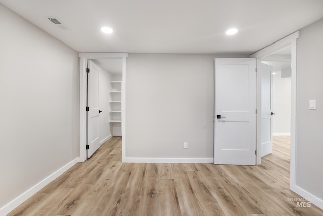 unfurnished bedroom with light wood-style flooring, baseboards, and recessed lighting