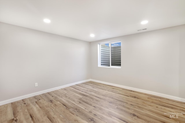 spare room with light wood finished floors, baseboards, visible vents, and recessed lighting