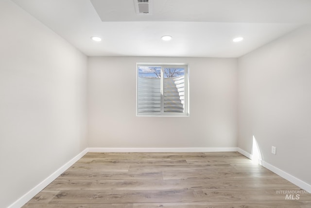 empty room with light wood-type flooring, visible vents, baseboards, and recessed lighting