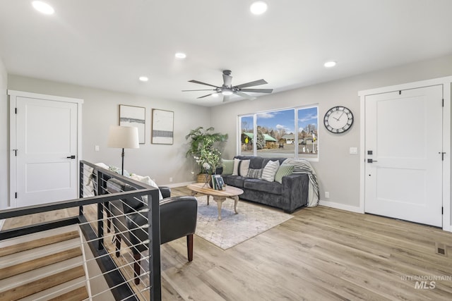 living area with a ceiling fan, recessed lighting, baseboards, and light wood finished floors