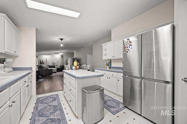 529 S State St, Nampa, ID 83686 - kitchen with freestanding refrigerator, a center island, and white cabinetry