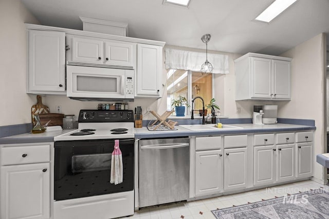 529 S State St, Nampa, ID 83686 - kitchen with stainless steel dishwasher, white microwave, electric stove, a sink, and white cabinets