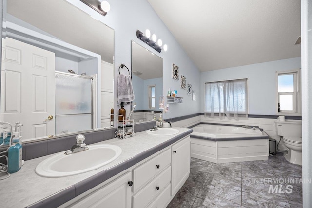 529 S State St, Nampa, ID 83686 - full bathroom with vaulted ceiling, a bath, double vanity, a shower stall, and toilet