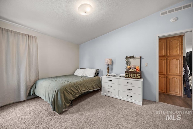 529 S State St, Nampa, ID 83686 - carpeted bedroom with vaulted ceiling and a textured ceiling