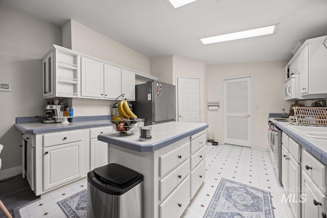 529 S State St, Nampa, ID 83686 - kitchen featuring stainless steel appliances, white cabinetry, a center island, and open shelves